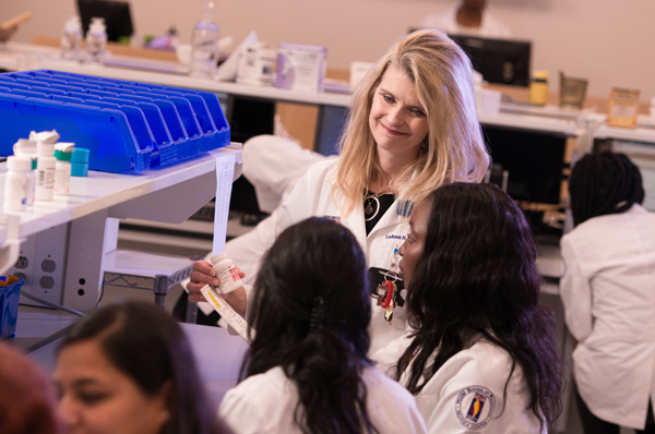 PharmD faculty member and students in lab setting