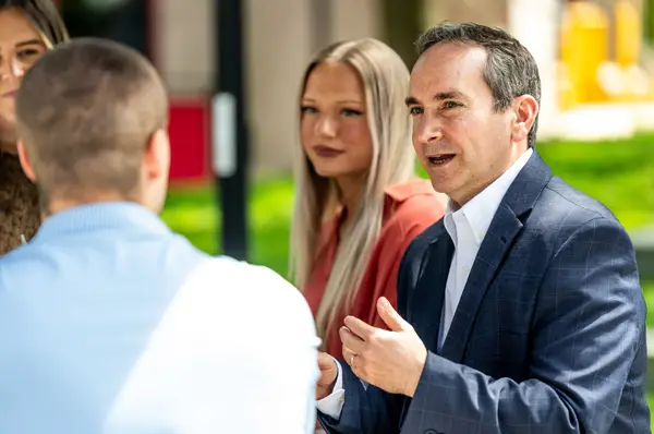 PCOM MAPP program director Dr. Scott Glassman smiles while speaking with students on campus