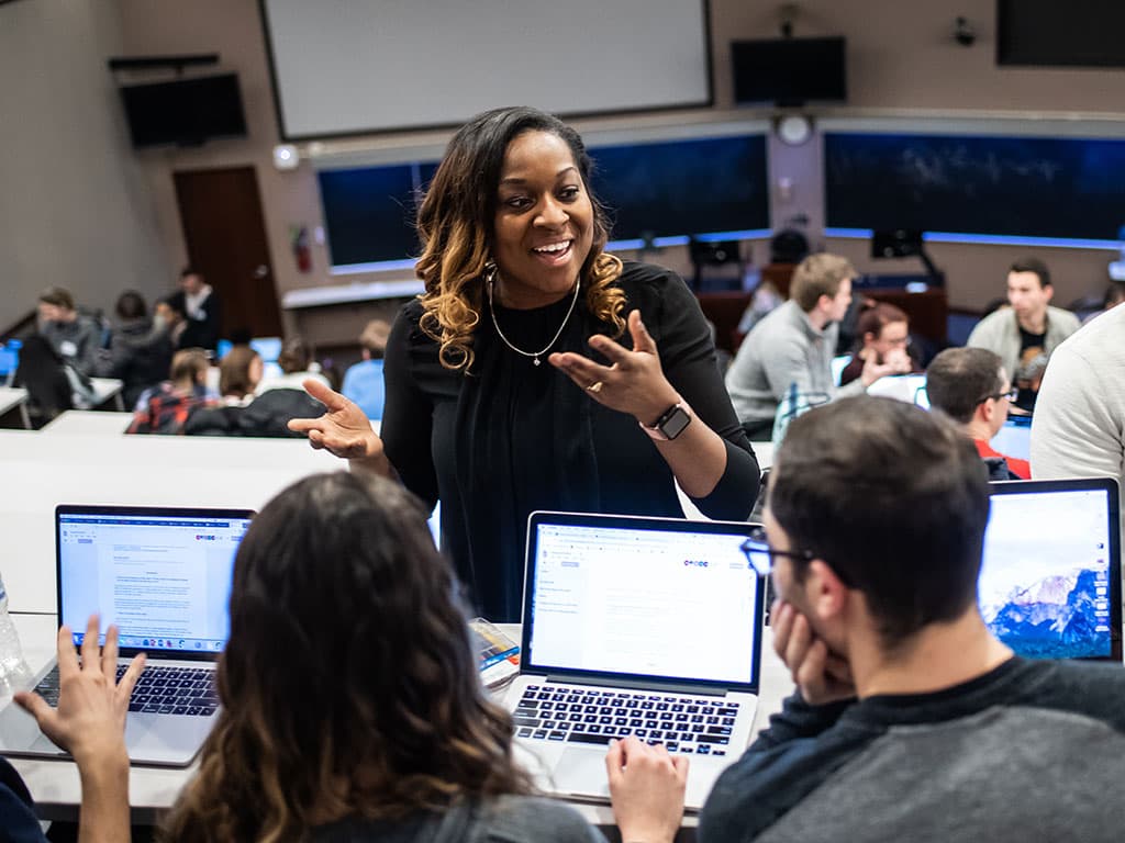 PCOM psychology students talking and interacting in a lecture hall during a learning exercise