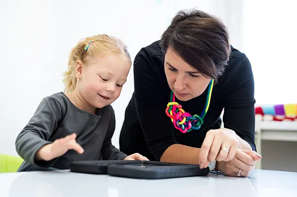 Child psychologist plays a game with a young girl