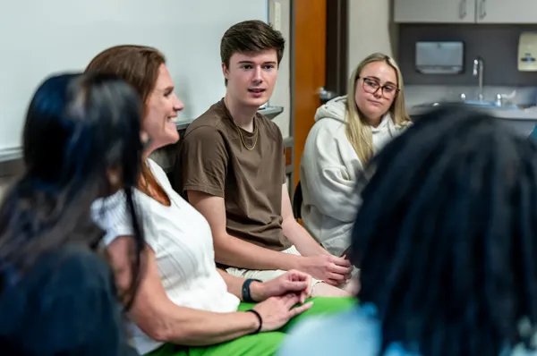 PCOM psychology students and faculty talk to visitors during a campus tour event on the Philadelphia campus