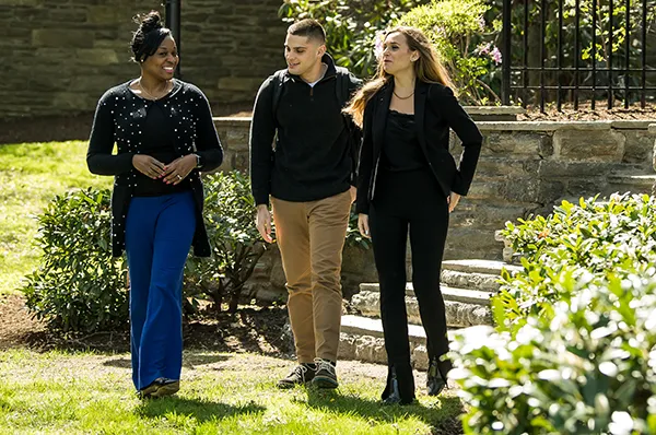 Clinical psychology students walk along the campus courtyard