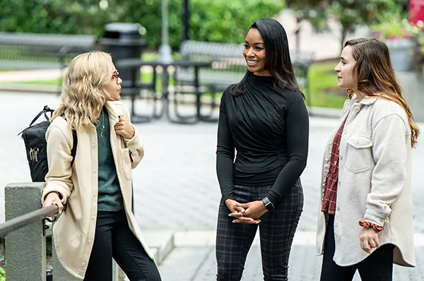 Clinical psychology students meet together in the courtyard