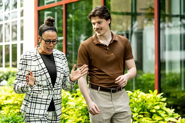 Clinical psychology student walks across campus with Dr. Melissa “Missy” Terlecki