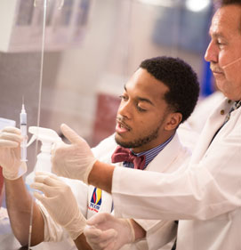 Dr. Smallwood, a nuclear pharmacist, instructs a pharmacy student. Nuclear pharmacy is one specialties PCOM School of Pharmacy prepares graduates to pursue.