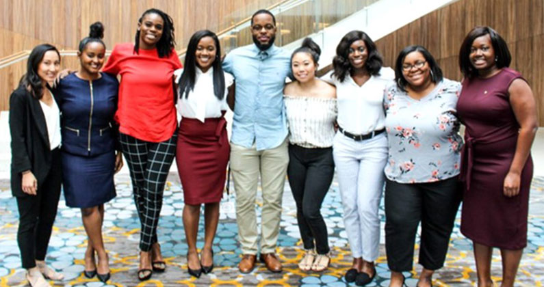 PCOM Georgia pharmacy students smile and pose in a lobby at the Kappa Psi Pharmaceutical Fraternity's 59th Grand Council Convention