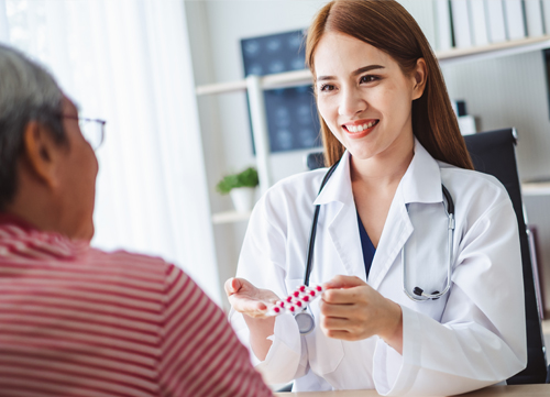 Pharmacist recommending medication to an elderly patient