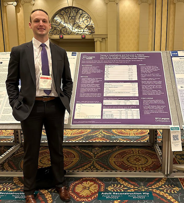 David Cieremans, MS, standing with his research poster on total hip arthroplasty at the AAOS conference.