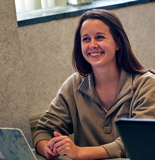 PCOM school psychology student smiles in a classroom.