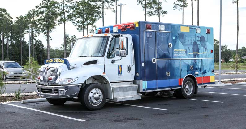 Side view of the mobile education simulation lab ambulance in the PCOM South Georgia parking lot