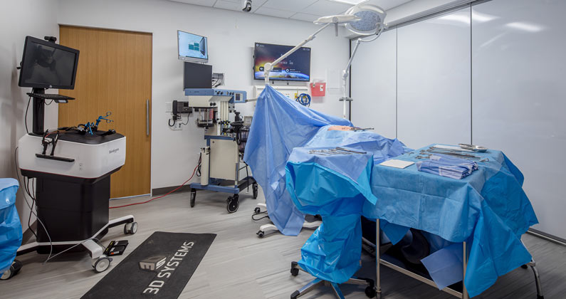 Operating table, monitors, tables and equipment in the simulated operating room at PCOM South Georgia