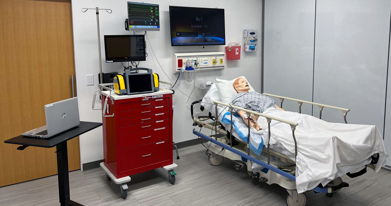 Advanced adult patient mannequin in a hospital bed in the PCOM South Georgia Simulation Center
