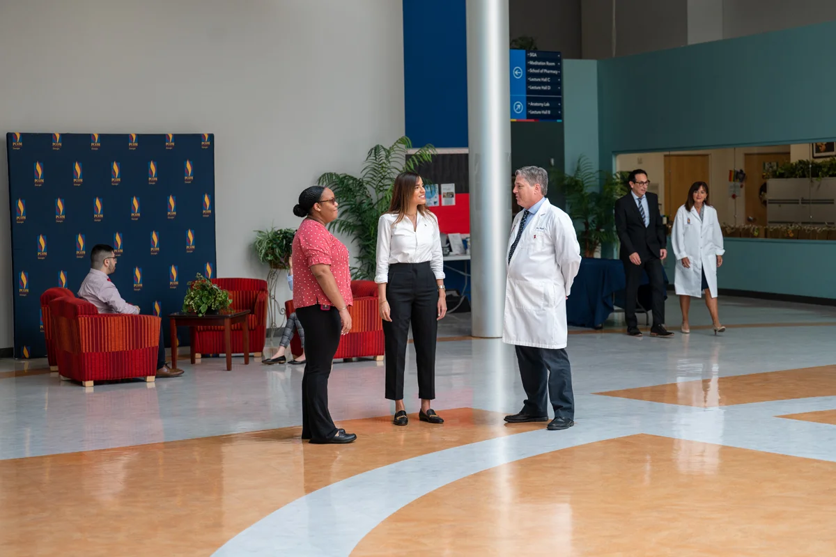 PCOM Georgia students and faculty talking in the Atrium at PCOM Georgia