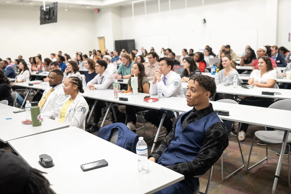 A lecture hall filled with students during a class