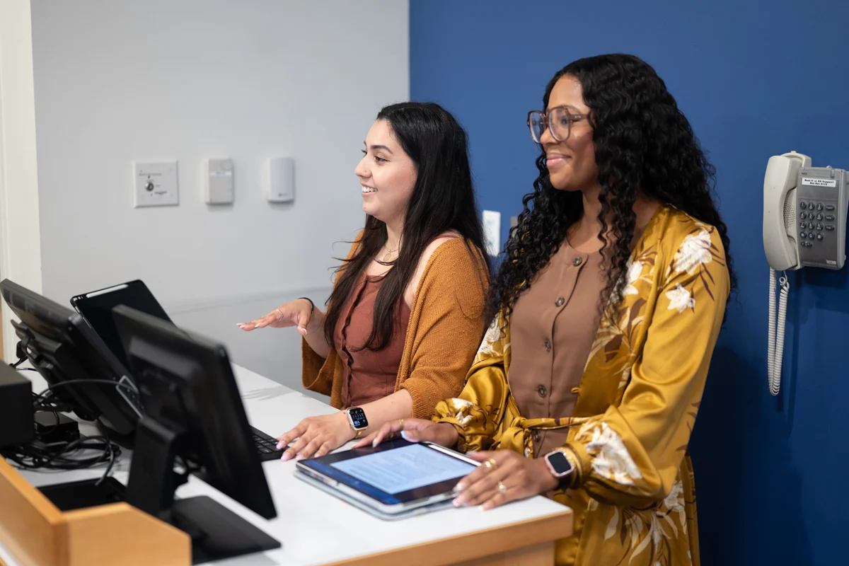 Students smile as they present in front of a class at PCOM Georgia