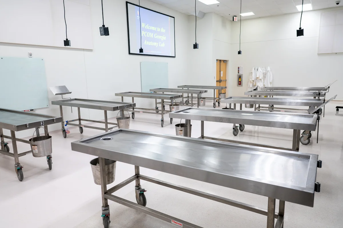 Dissection tables and audio/video learning equipment in the anatomy lab at PCOM Georgia