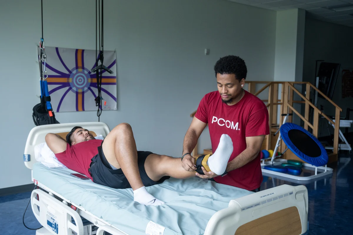 DPT students conducting stretches on a table in the lab