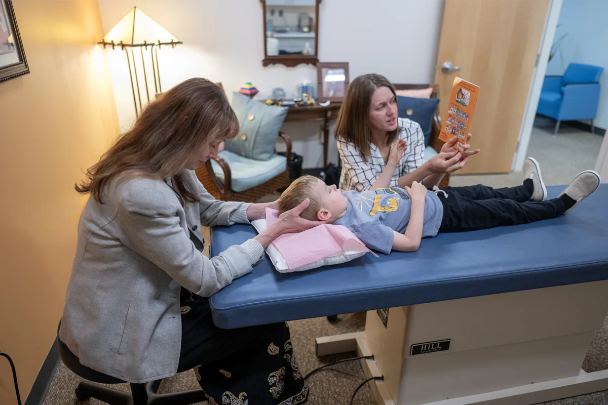 A PCOM Georgia physician examines a child in an exam room at the GA OCC