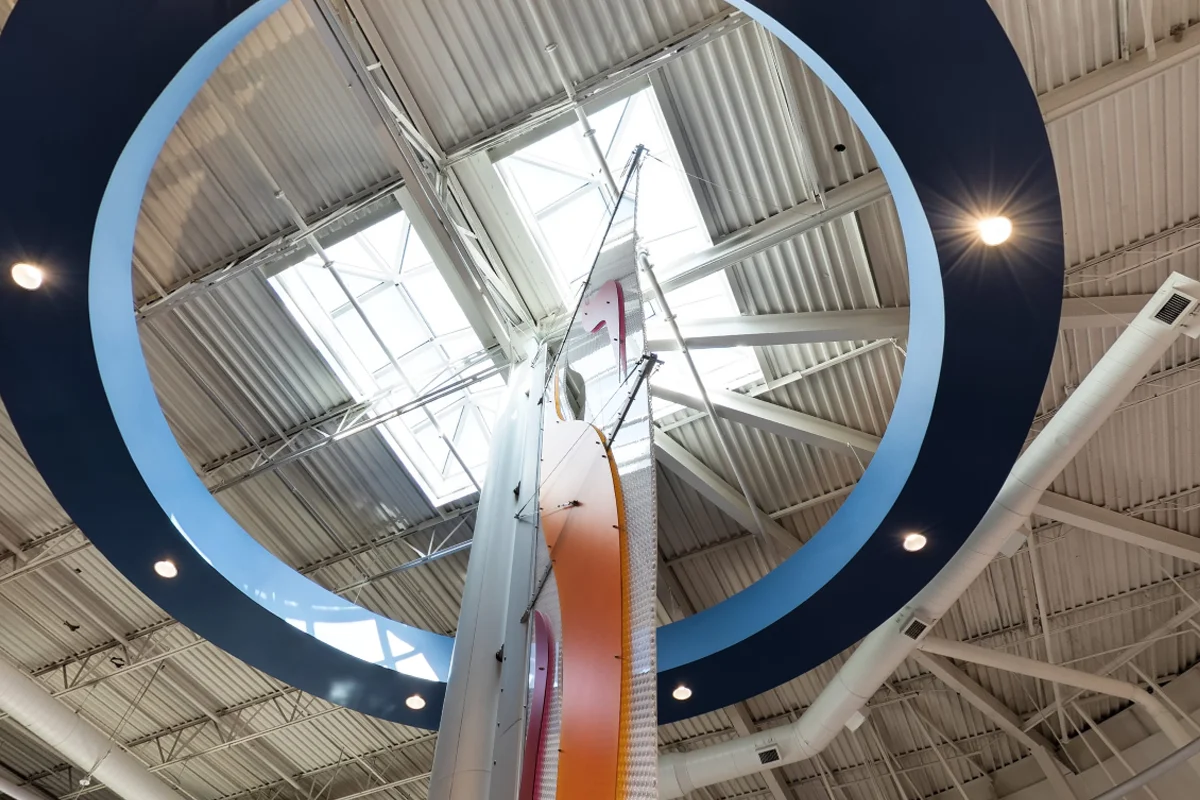 Wide view of the open space window, flame sculpture and ceiling of PCOM Georgia's main lobby