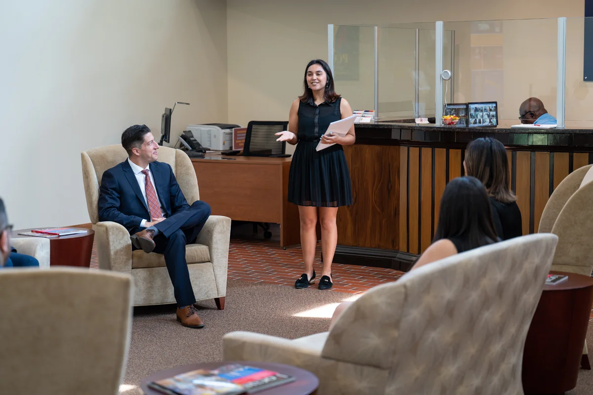 Admissions staff member smiling and talking during a tour in the Northlake lobby