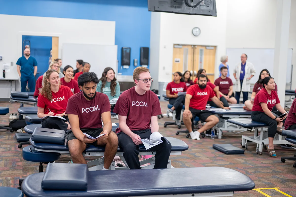 Students listening to instructions during an OMM lab