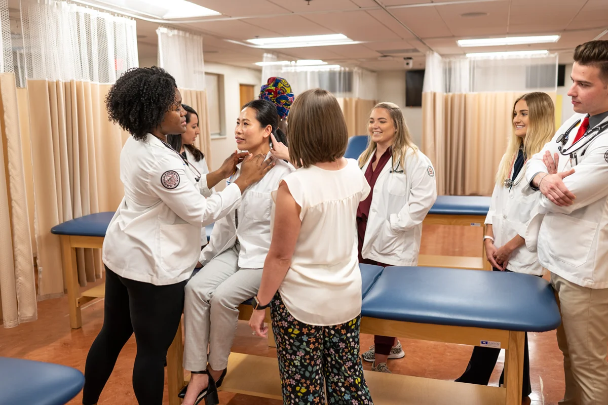 Physician assistant studies students practicing exam techniques