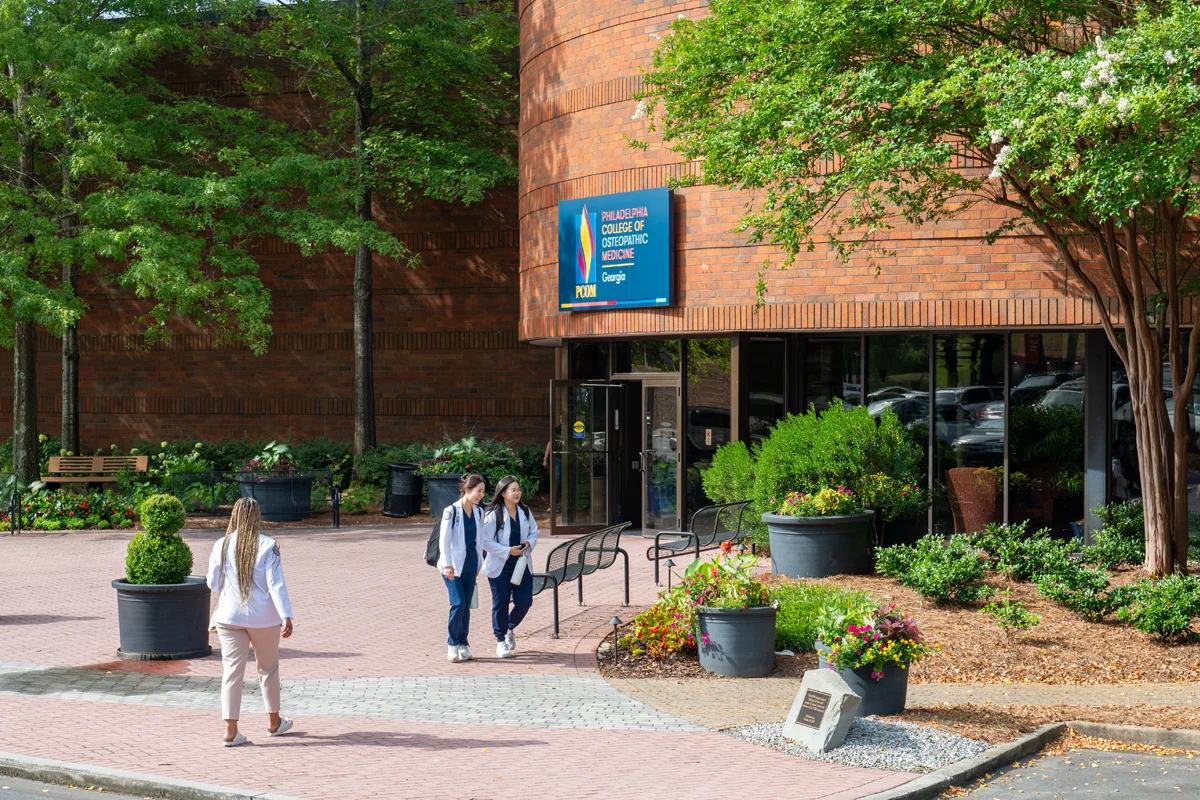 Students walking in front of PCOM Georgia's main building