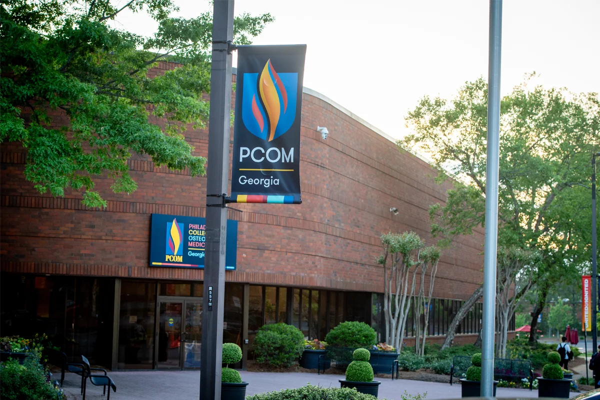 View of a PCOM banner in front of a facade of the Old Peachtree building