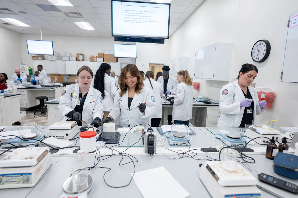 Students working in a pharmacy compounding laboratory