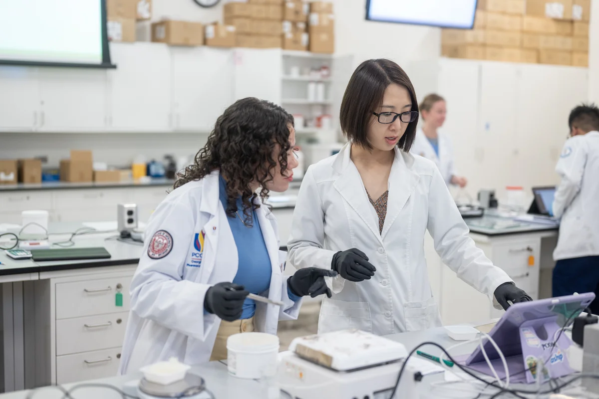 A PharmD student and instructor work together in a lab