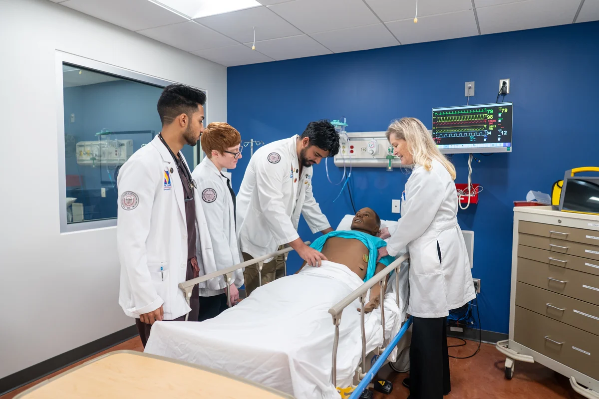 PCOM Georgia med students practice hands-on trauma exercises on a simulated mannequin