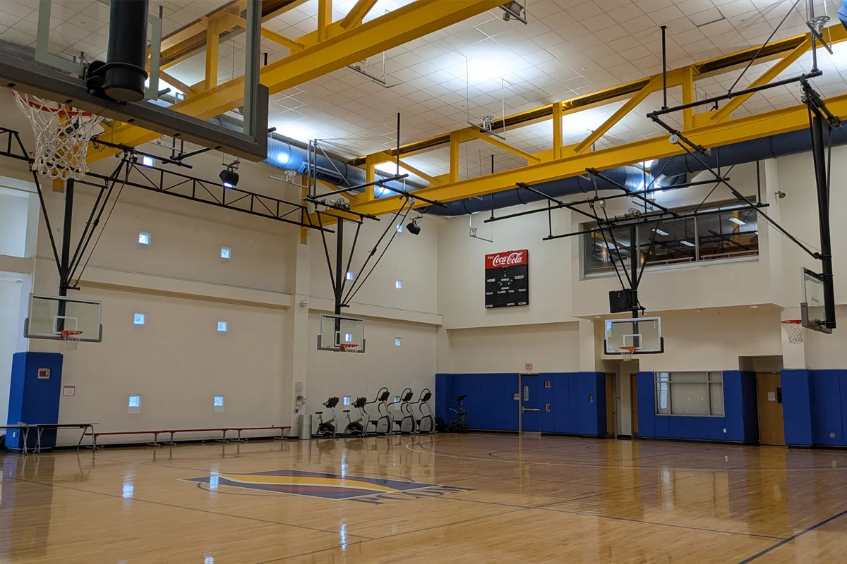 Gym floor, basketball court, hoops and exercise equipment in the PCOM Activities Center