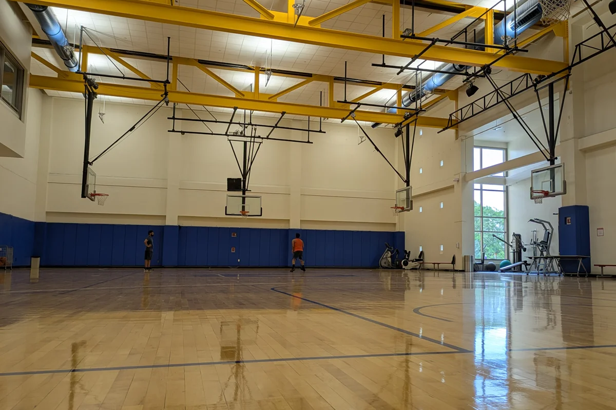 Gym floor, basketball court, hoops and exercise equipment in the PCOM Activities Center