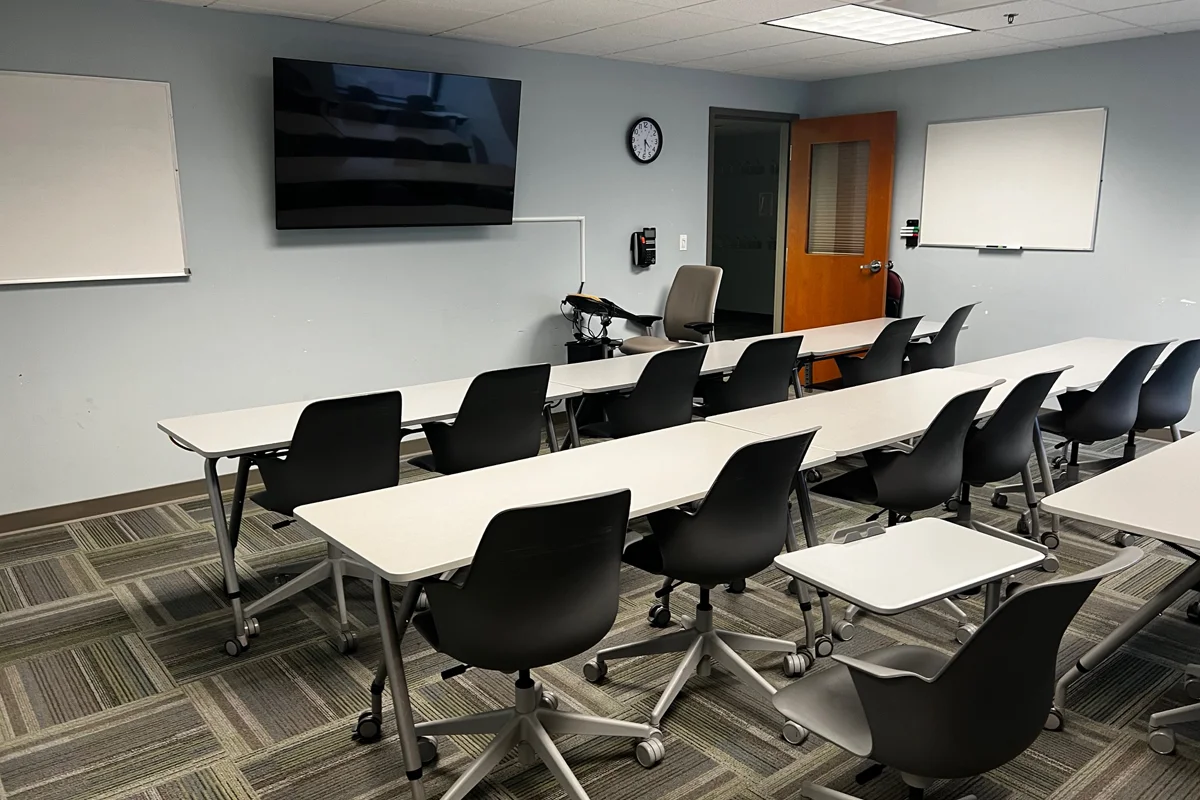 Rows of tables and chairs in the CLAC's debriefing room