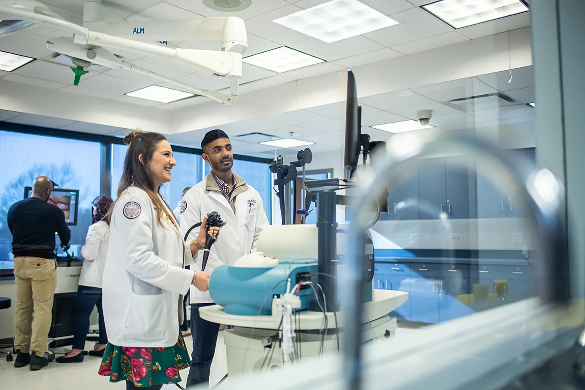 Med student concentrating as she uses surgery simulation equipment in the PCOM CLAC