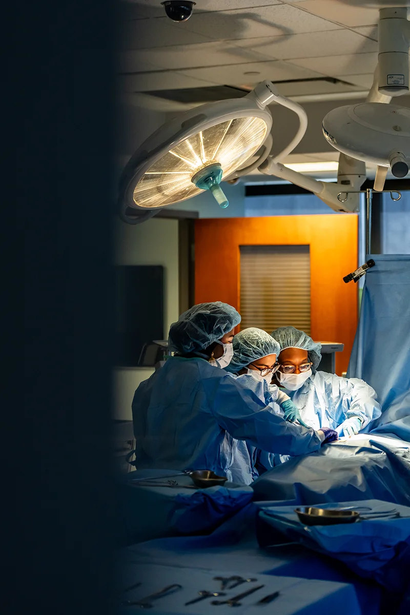 Students working on simulation surgery table equipment in the Saltzburg CLAC