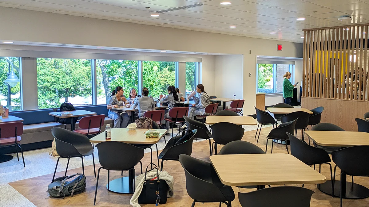 Students sitting and talking during lunch in the PCOM Dining Commons