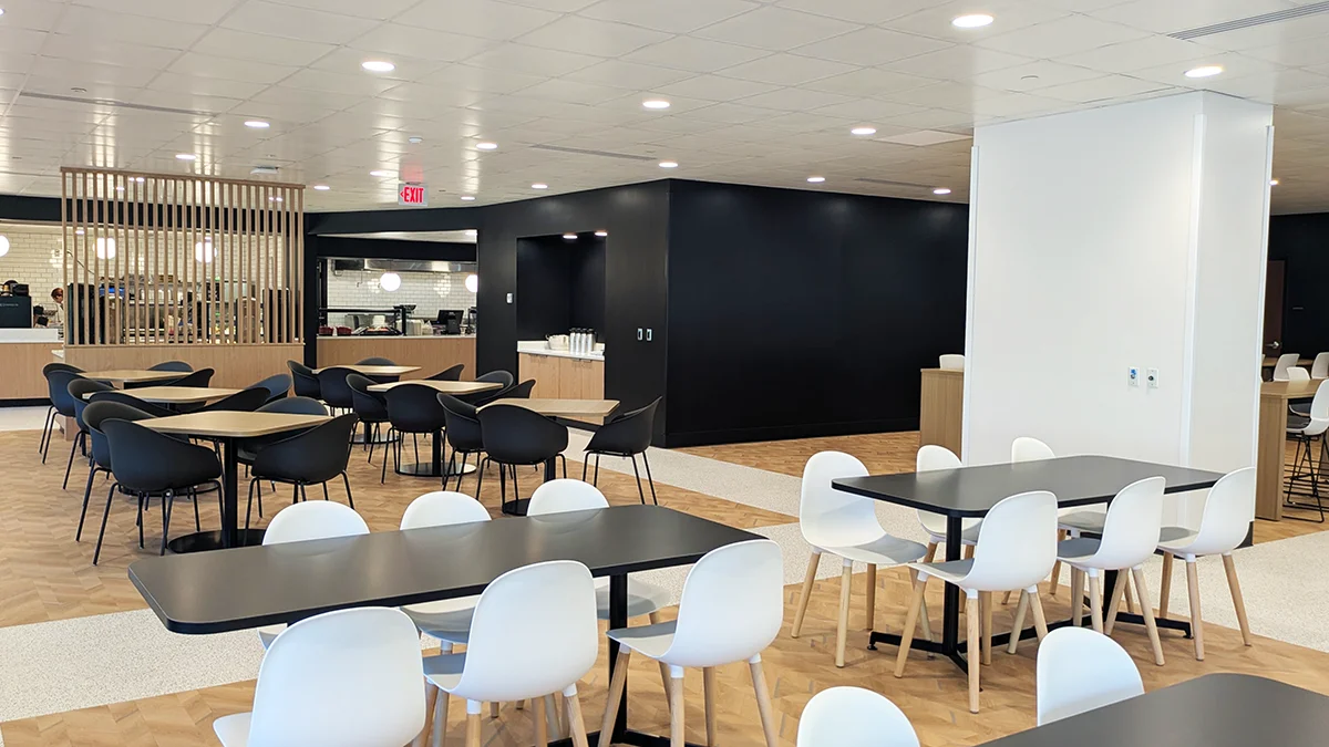 Seating, tables and windows within the dining area of the PCOM Dining Commons