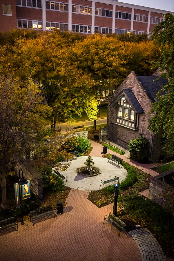 Aerial view of PCOM's Gober garden and fountain area at dusk