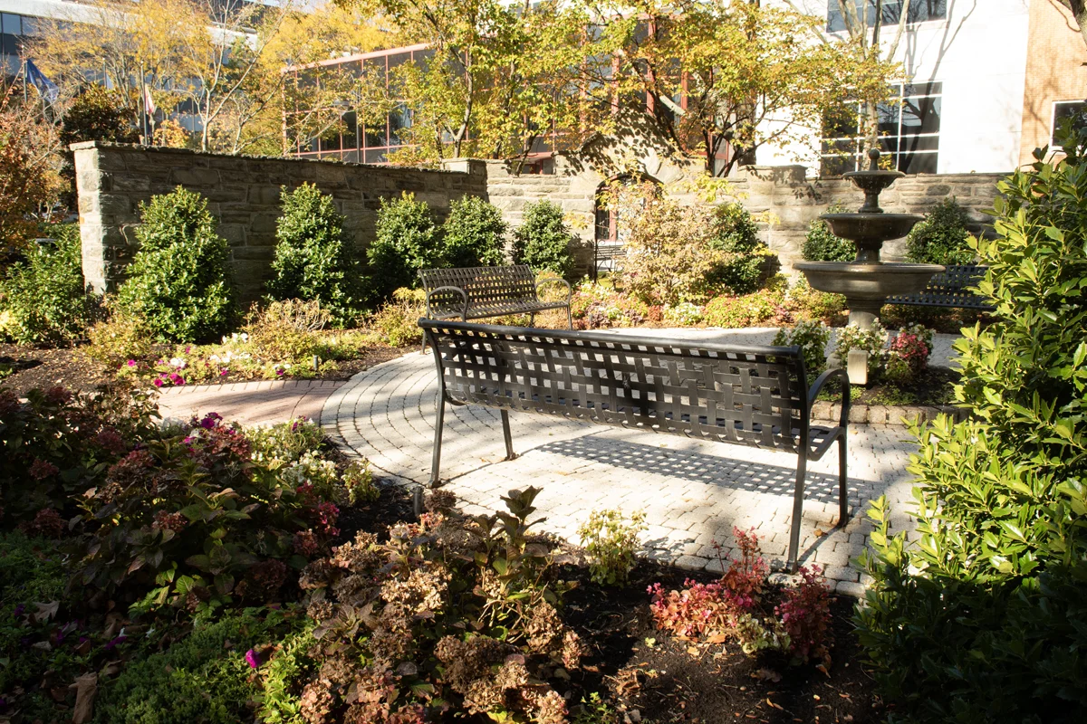 Wide view of the benches, wall, fountain and landscaping in the donor garden at PCOM