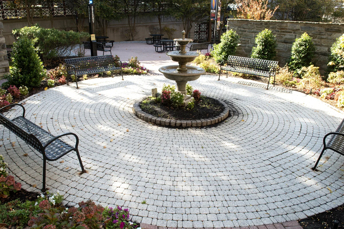 Fountain and circular brick landscaping in the Robert Gober, DO '78, Fountain and Donor Garden