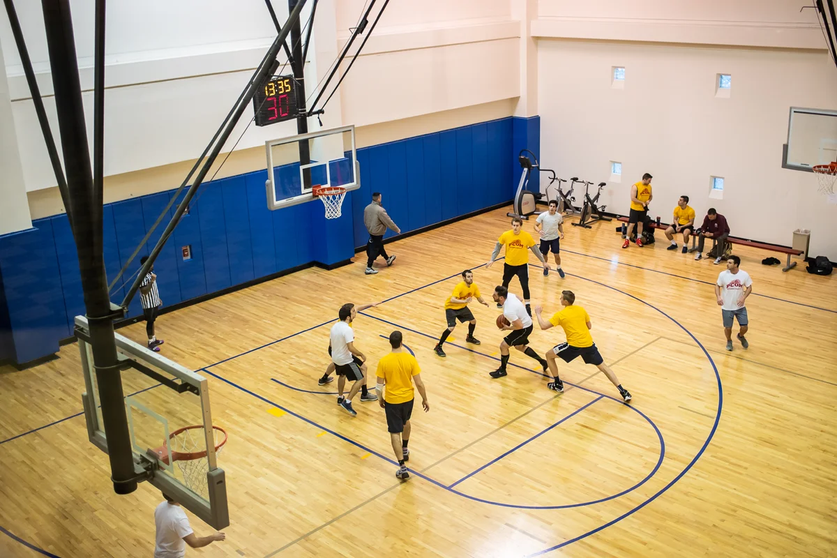 Aerial shot of students playing a rec league basketball game on the sports court
