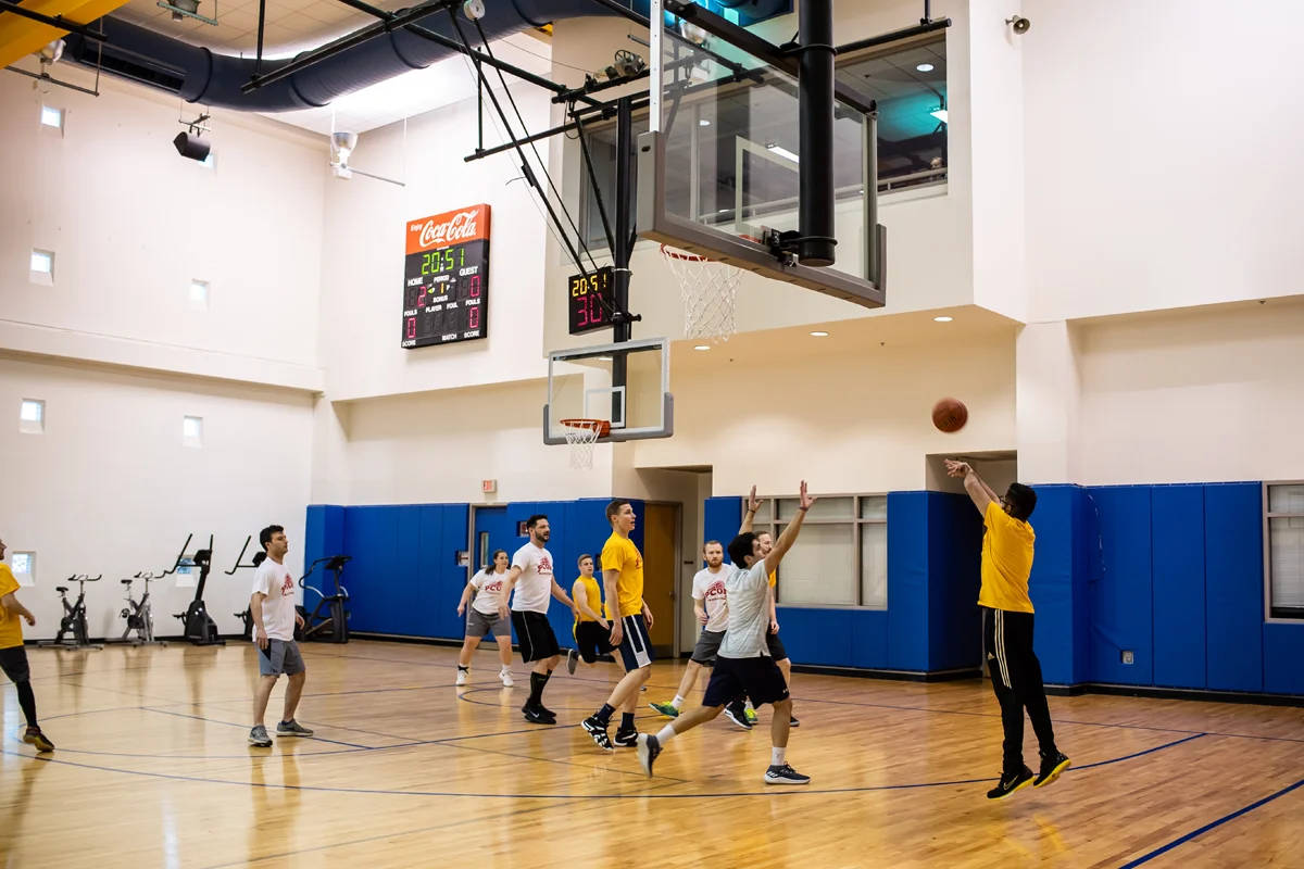 Students playing a basketball game in the gym