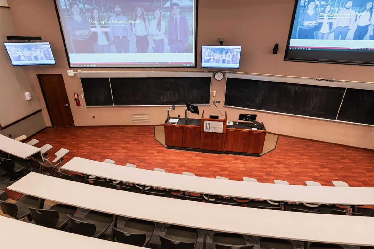 View down toward the lecture podium and large monitors in one of PCOM's amphitheaters