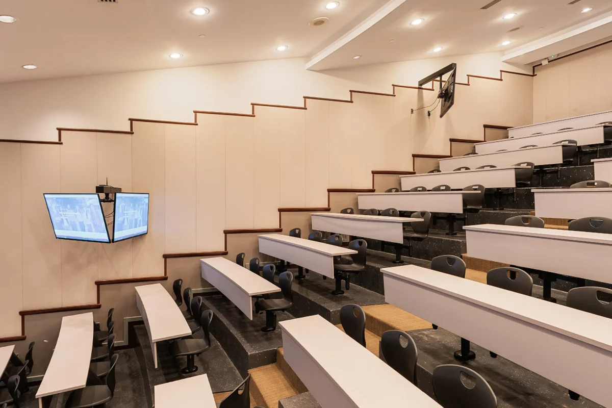Side view of the rows of long tables and chairs in the amphitheater lecture hall