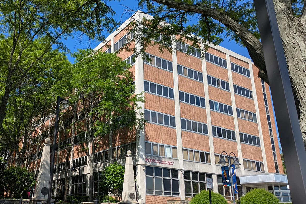 Looking up at the faccade of the main classroom building of PCOM's Howard A. Hassman, DO '83, Academic Center