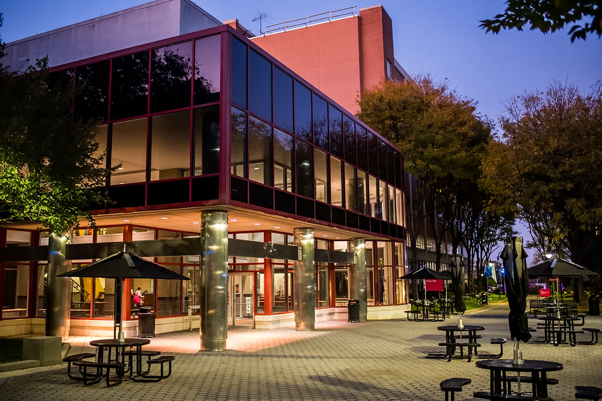 View of the Hassman building faccade from the courtyard at dusk