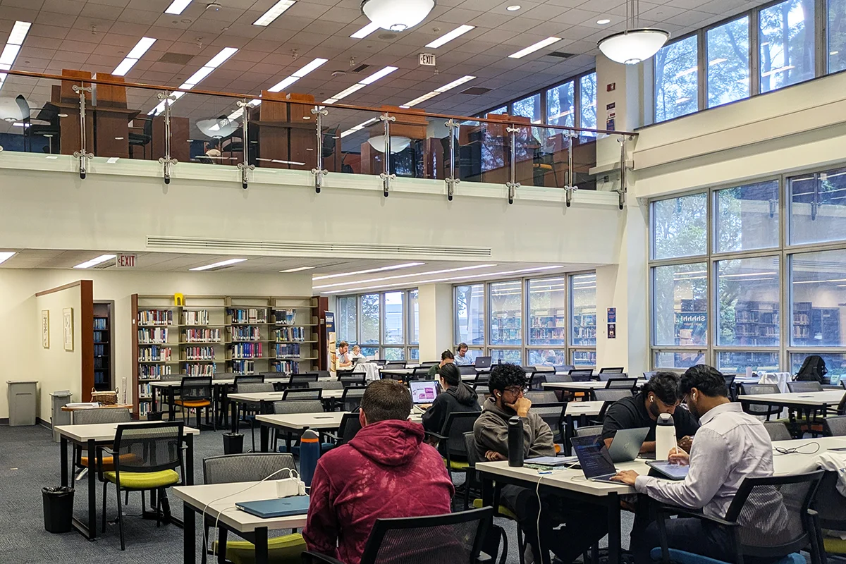 Students studying at tables within the OJ Snyder Memorial Library within PCOM's Hassman Academic Center