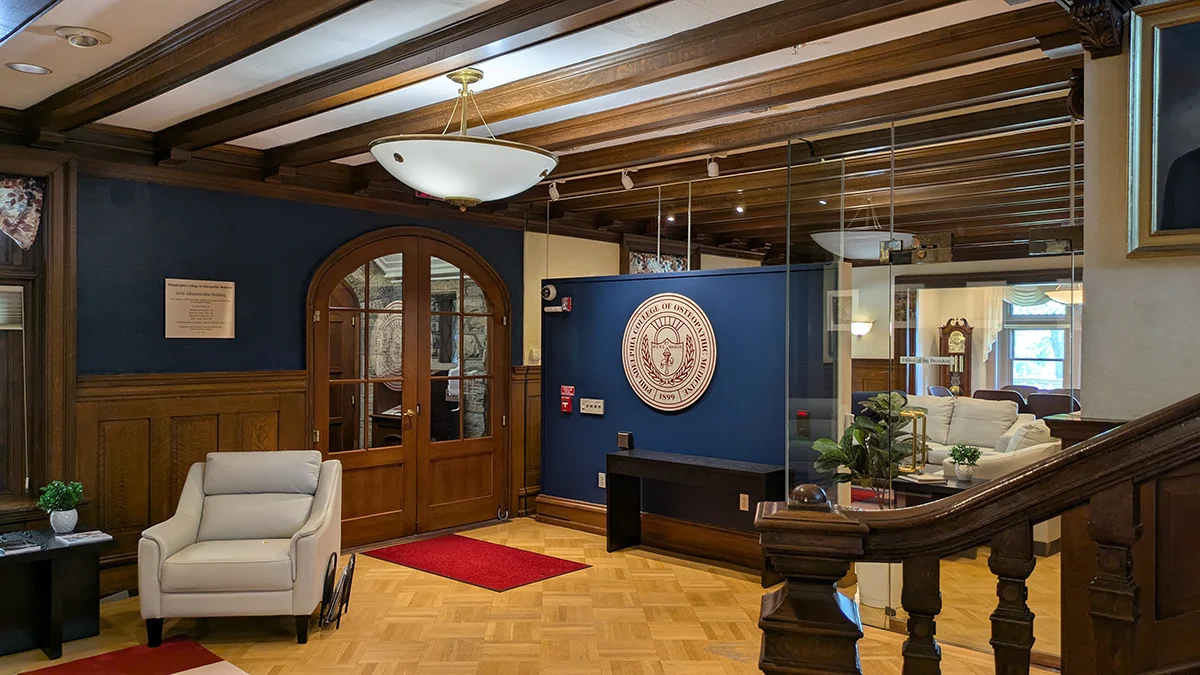 Front lobby of PCOM's Levin building with seating, tables and a view of the President's Office