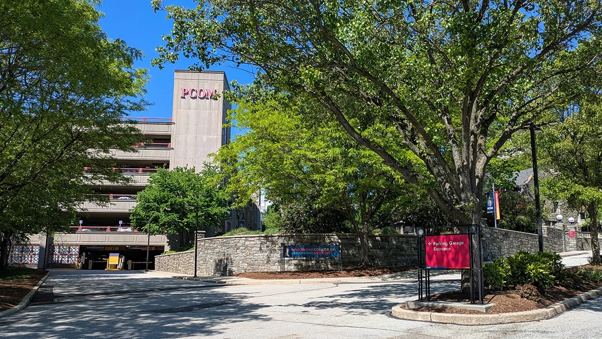 Parking garage building, side entrance, side street view and surrounding landscaping